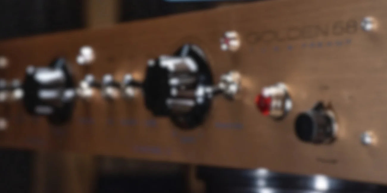 Angled Golden58 product artwork showing the gold faceplate and black gain controls